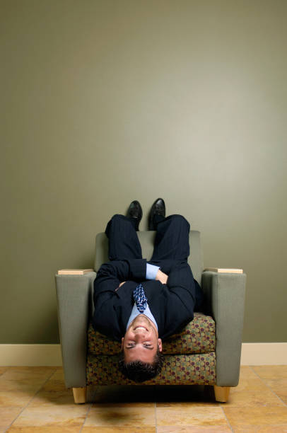 istock Young executive lying upside down in chair 172174767