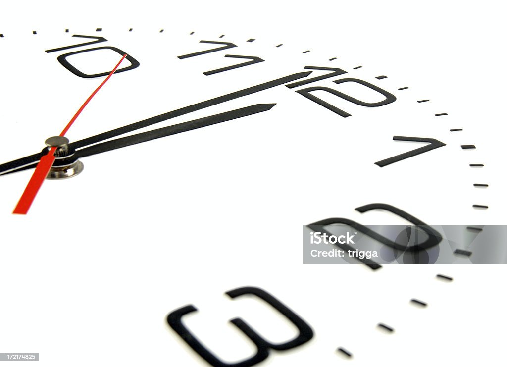 One minute to midnight Clock face showing one minute to midnight. Clock Stock Photo