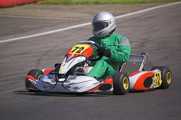 A go kart and driver racing round a track Professional Go Kart in action go carting stock pictures, royalty-free photos & images