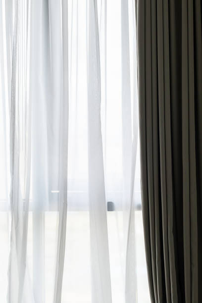 istock Curtain draperies at window, close up. 1721754929