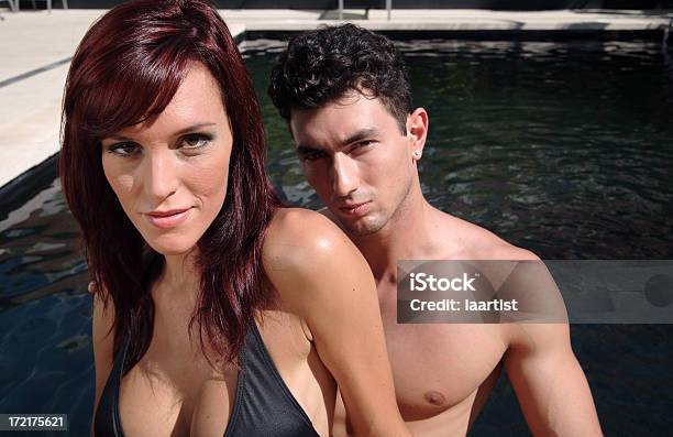 Pareja Junto A La Piscina De Hidromasaje Foto de stock y más banco de imágenes de Escote - Escote, Parejas, Adulto