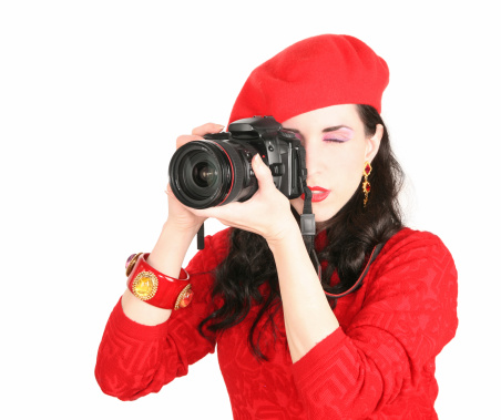 Picture of a woman in red with a camera.