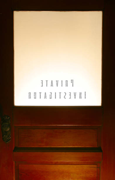 The inside of a private investigator's office door Woden door with a frosted glass panel marked Private Investigaor frosted glass door office stock pictures, royalty-free photos & images