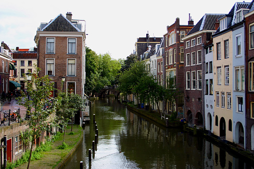 Amsterdam, Netherlands. Panoramic view of channels in amsterdam city. Dancing houses. River Amstel. Old european landmark. City autumn fall landscape with blue sky clouds.