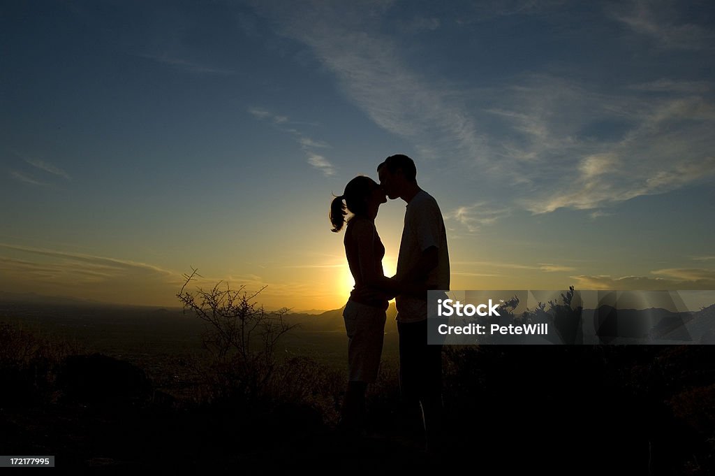 Sunset Kiss A couple kissing at sunset Adult Stock Photo