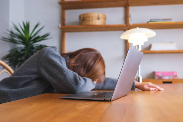 istock A woman get tired and asleep at desk while working on laptop computer 1721788100