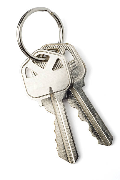 Isolated Keys on White with Clipping Path Two keys on a keychain isolated on white with clipping path. house key photos stock pictures, royalty-free photos & images
