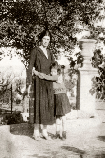 Vintage photograph of a mother being hugged by her daughter