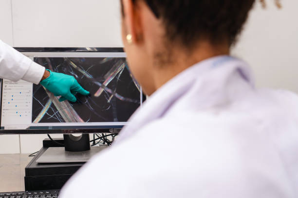 istock Latin American graduated student talking with professor about scientific micrograph data from laboratory equipment, professor pointing at computer screen to examine a result with student in university laboratory 1721794577