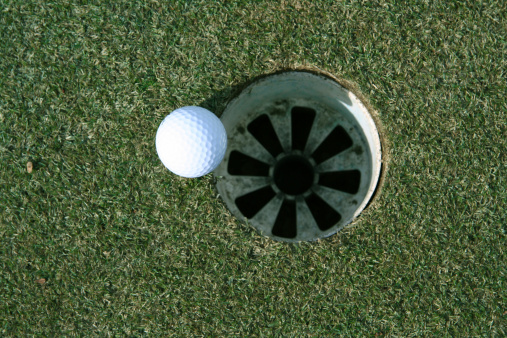 A golf ball that is just short of the hole.View more sports photos:
