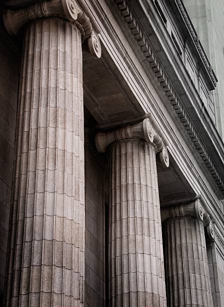 Gray ionic columns at the front of a traditional building Bank Exterior with Ionic Columns, early in the morning justice concept stock pictures, royalty-free photos & images