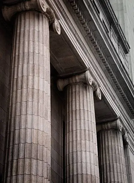 Photo of Gray ionic columns at the front of a traditional building