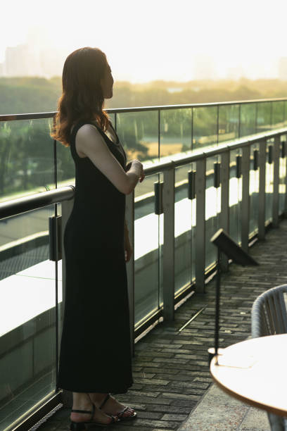 istock Young beautiful woman relaxing at sunset balcony 1721797225