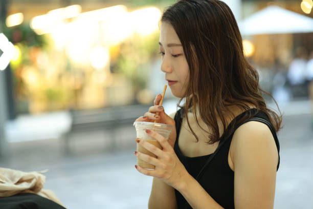 istock Young beautiful woman dinking coffee at shoping street 1721797819
