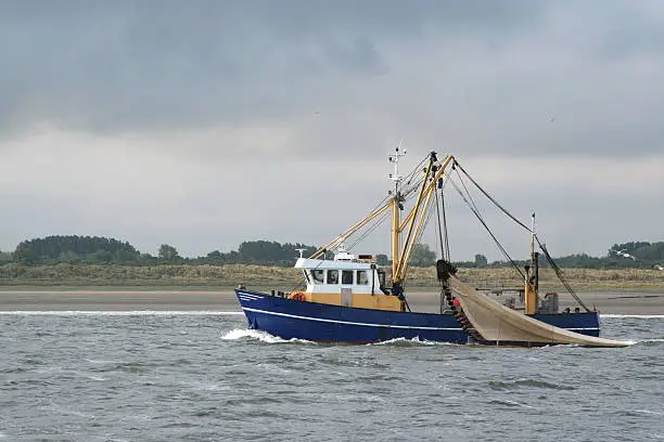 Dutch fishingvessel with lifted nets