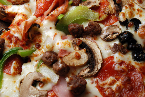 Macro shot of an all-dressed pizza.