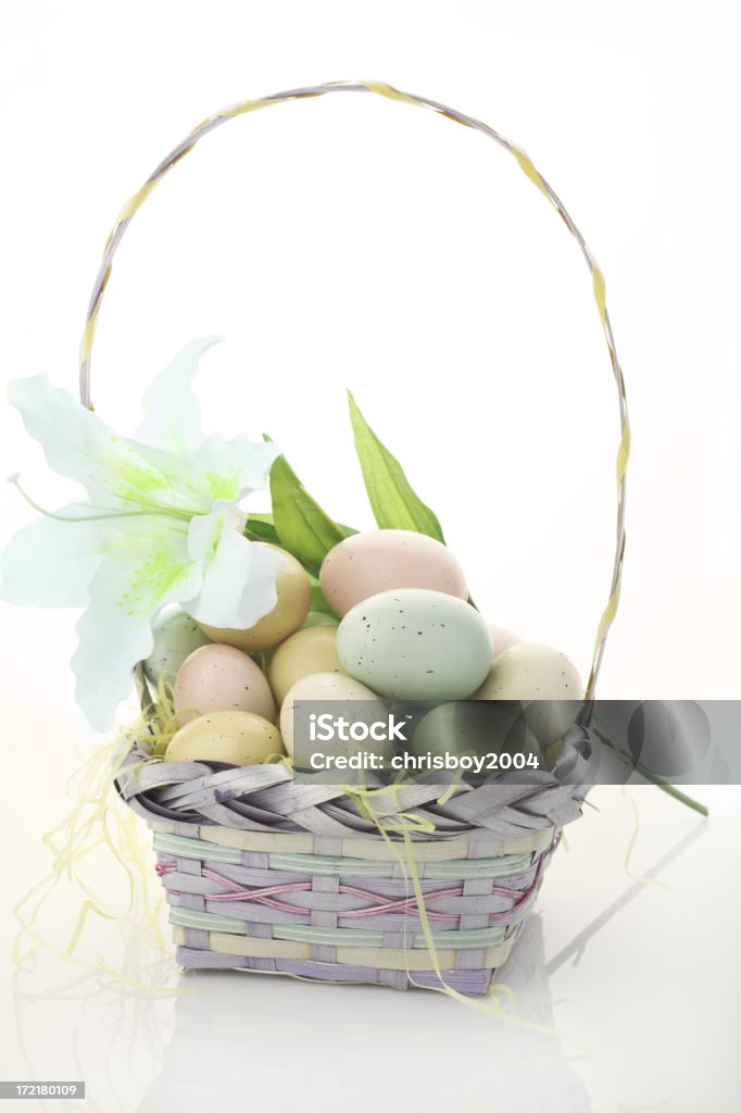 Easter Basket basket of decorated easter eggs with a lily Animal Egg Stock Photo