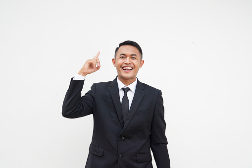 Portrait Young Asian businessman get a idea, smart, finger pointing up, isolated on white background