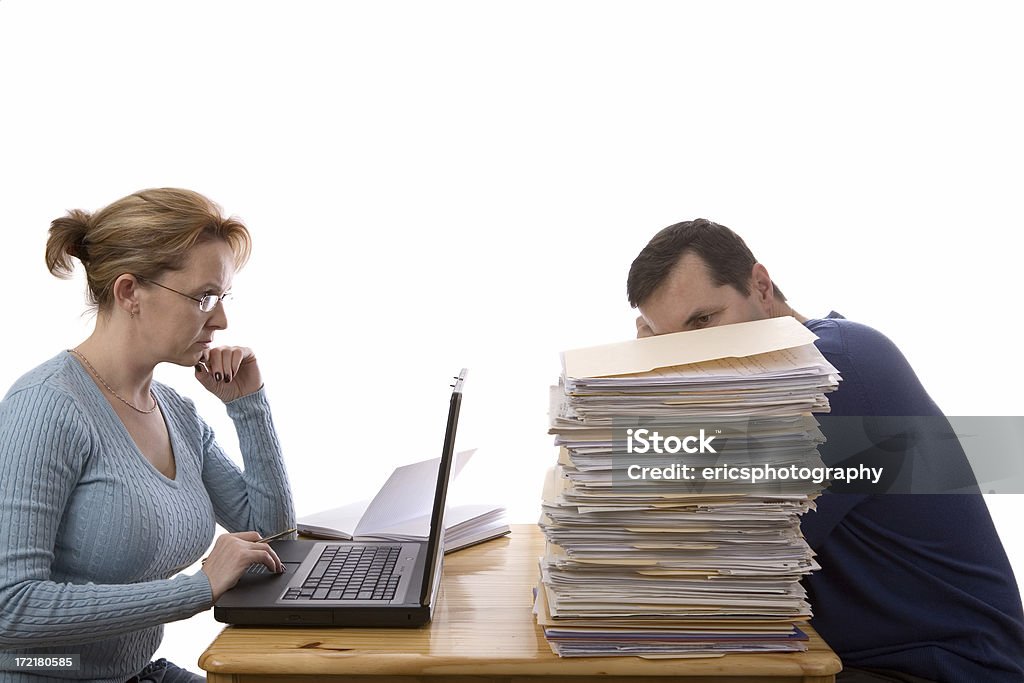 Two ways of doing income tax return A couple sitting at the table and preparing income tax return in two different ways. Isolated on white. Banking Stock Photo