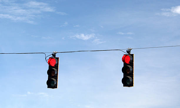 istock Red traffic signals hanging in sky 172181074