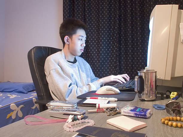 asian student on the computer stock photo