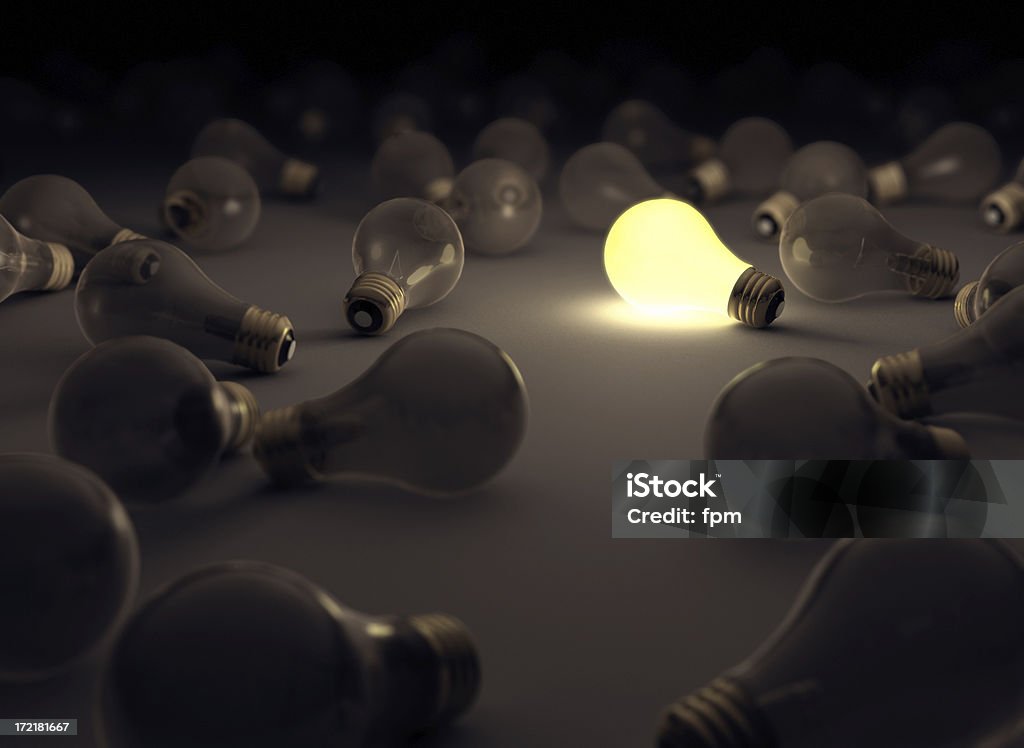 Creativity Concept 2 One lit bulb in a field of dim ones. (Focus on bright light bulb) Creativity Stock Photo