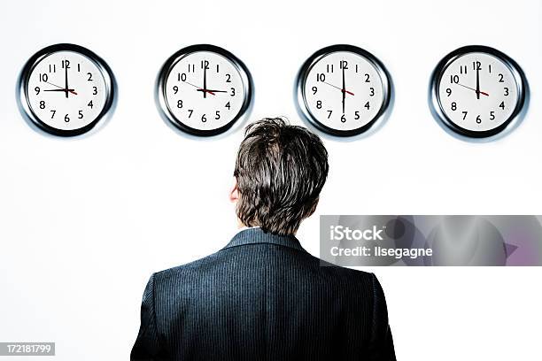 Businessman Looking At Clocks Stock Photo - Download Image Now - Adult, Adults Only, Business