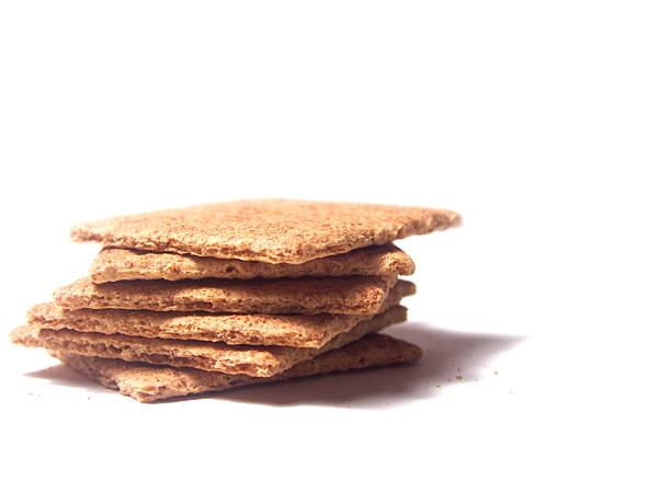 Stack of Graham crackers on a white background Cinnamon flavored. Graham Cracker stock pictures, royalty-free photos & images