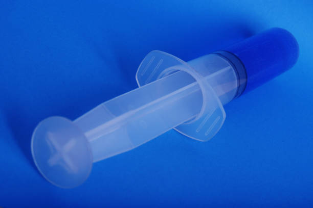 another syringe with the same blue stuff stock photo