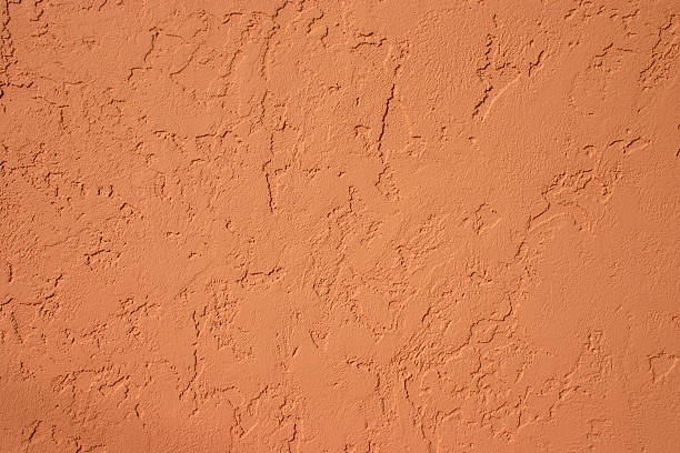 Stucco Surface Terra cotta colored stucco surface. Textured surface. Adobe wall. adobe material stock pictures, royalty-free photos & images