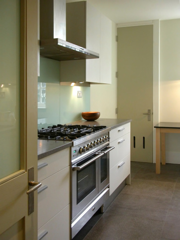 Kitchen interior with range cooker and glass splashback