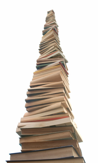 A very tall stack of books.  Perspective view that is reminiscent of a skyscraper.