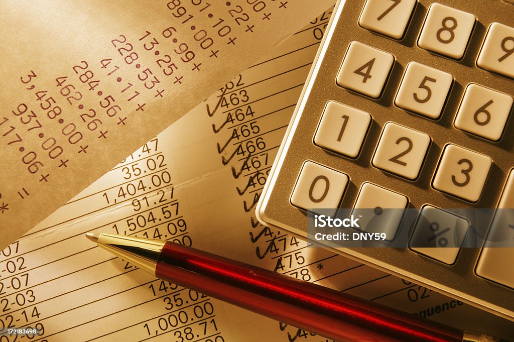 Checkbook being balanced using a calculator on ballpoint pen A close up of a checkbook, calculator, and red ballpoint pen.  The pen and calculator are resting on top of a bank statement.  Each line item is being checked off as each payment is accounted for.  A section of calculator tape is visible.  A golden brown color scheme dominates the image. Balance Stock Photo