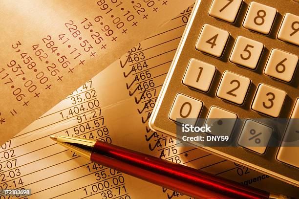 Checkbook Being Balanced Using A Calculator On Ballpoint Pen Stock Photo - Download Image Now