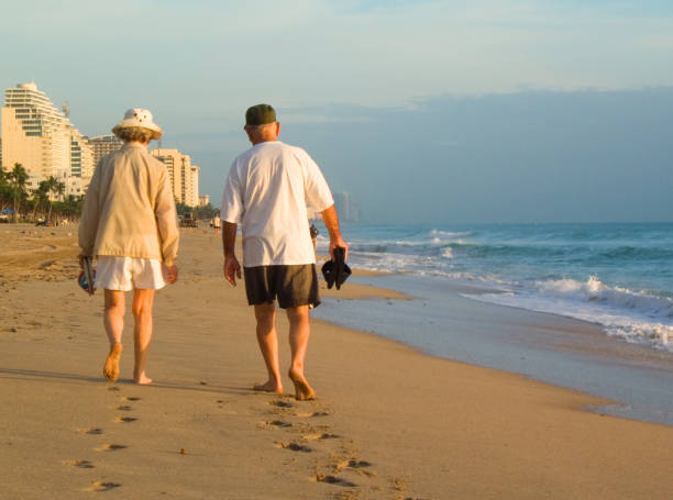 Older couple walking the beach at Fort Lauderdale at sunriseMore photos