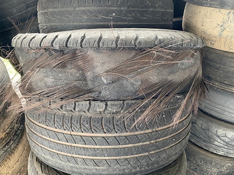 Closeup used tires. Old tyres waste for recycle or for landfill. Black rubber tire. Pile of used tires at recycling yard. Material for landfill. Recycled tires. disposal waste tires.