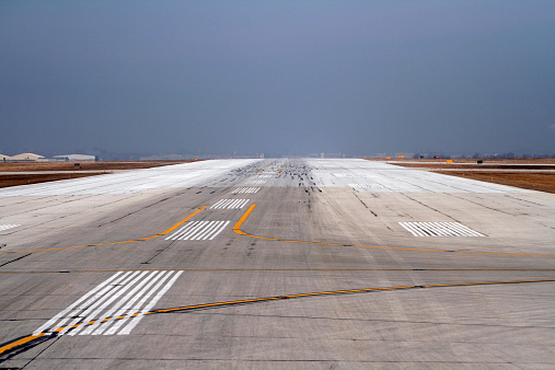 Airport runway showing tire skid marks from landing.
