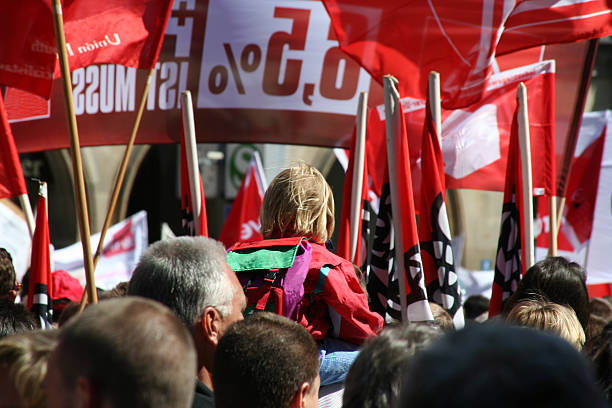 A demonstration of a group of people practicing their rights "May demonstration for higher salaries, organized by German Unions.Banners with slogans (Logos got removed)" labor union stock pictures, royalty-free photos & images