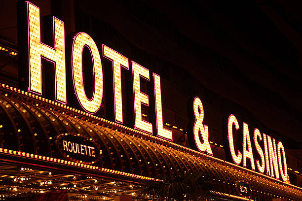 Diminishing perspective photo of a generic Las Vegas style 'Hotel & Casino' sign. Idendifiable portions of the building are cropped from view.