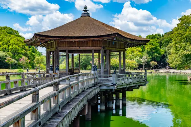 Typical Japanese buildings and architecture are mixed with beautiful traditional landscaping garden in this pier and lake in Nara, Japan