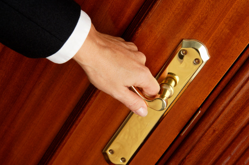 Hand with a golden doorknob