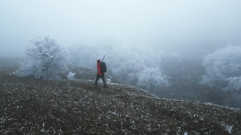 Young man tourist travel hiker walking to mountain