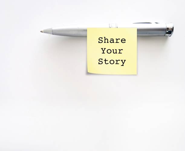 Pen on copy space white background with text written SHARE YOUR STORY, means to reveal personal story to the world or story behind your brand
