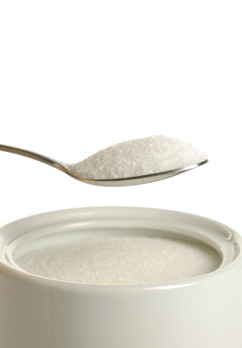 Spoonful of sugar over sugar bowl