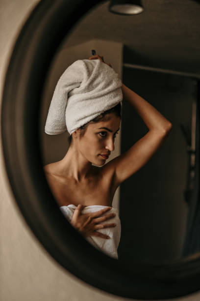 istock Happy smiling beautiful young woman applying moisturizer 1721859442