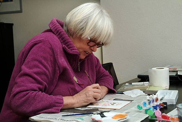 istock senior woman painting a tile 172186199