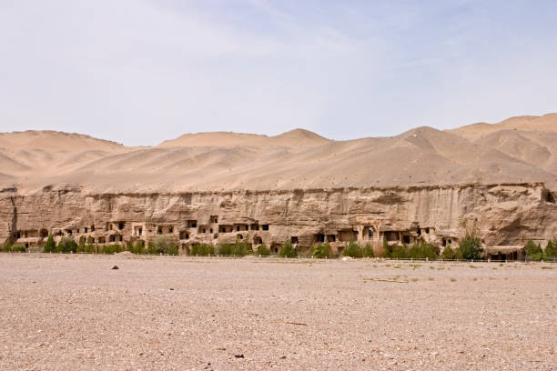 Mogao Caves near Dunhuang, Gansu, China. Ancient Buddhist temple complex carved into desert cliffs, surrounded by sand and dry landscape