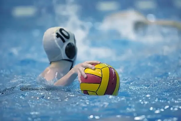 water polo player prepares to pass the ball