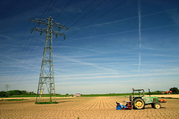 Farmland with tractors and a giant windmill