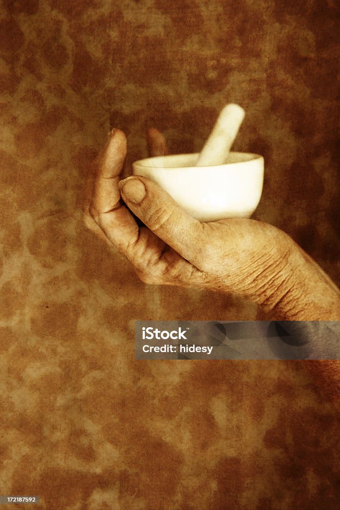 Shaman's Hand With mortor and pestle.  Grainy and grungy. Alternative Medicine Stock Photo